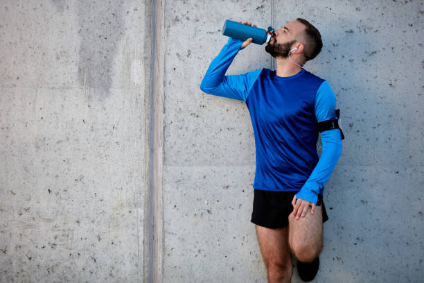 istock Man resting from running and drinking water. 1094237804