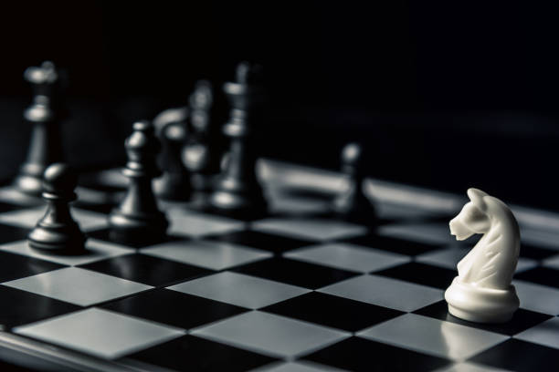 istock Chess board. White horse threatens black opponent's chess 1094238104