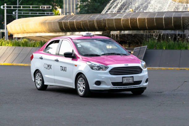 Ford Figo in taxi version driving on the street Mexico City, Mexico - 2nd January, 2019: Ford Figo Sedan/Aspire in taxi version driving on the street. This model is a popular low-cost car in Central America. tabasco state stock pictures, royalty-free photos & images