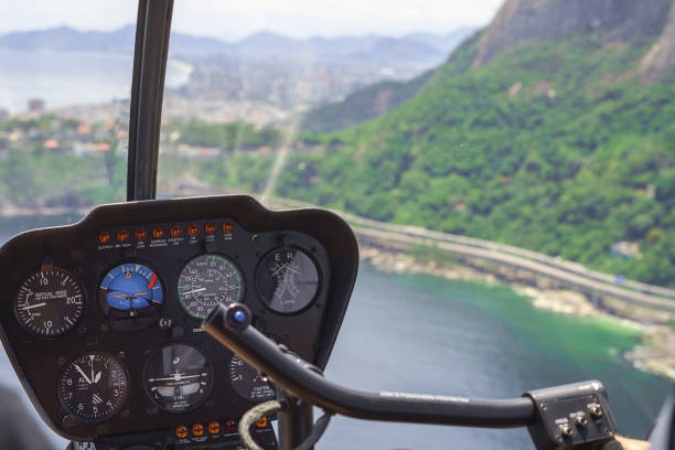 istock View from a helicopter cockpit flying over Rio de Janeiro, Brazil. Cockpit with instruments panel. Captain in the aircraft cockpit. Selective focus, Horizontal 1094243272