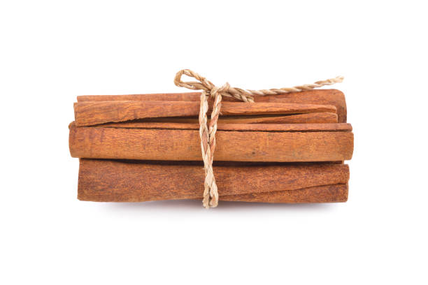 tie a rope dried cinnamon sticks on white background