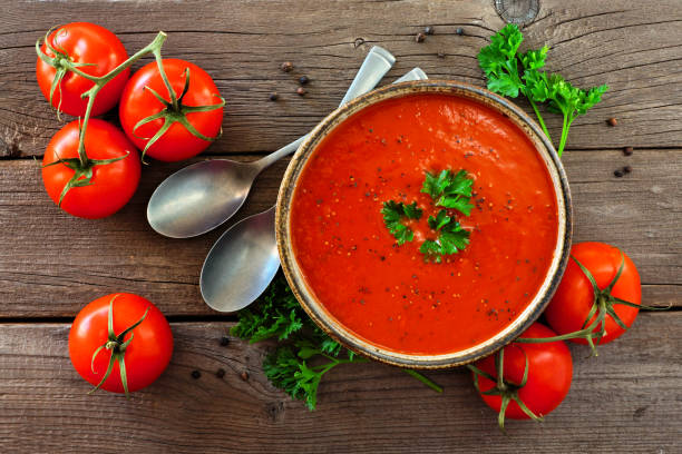 istock Tomato soup, view from above, table scene on a wood background 1094246728