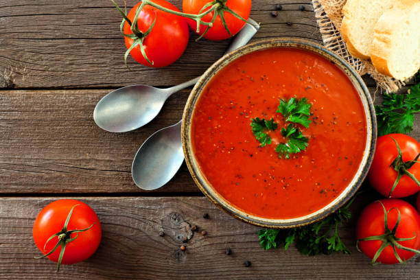 istock Tomato soup, top view, table scene on a wood background 1094246778