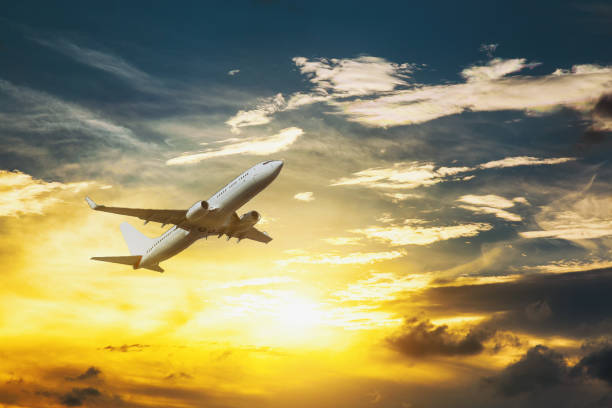istock White passenger double decker plane in flight high above the golden clouds during the sunset. 1094248234