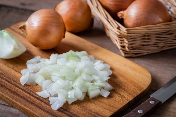 istock Fresh chopped onions on wooden cutting board 1094252190