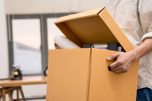 istock business man are stressed from being fired from work and holding brown cardboard box.unemploy or resign concept. 1094254432