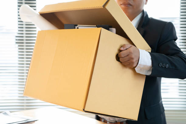 istock business man are stressed from being fired from work and holding brown cardboard box.unemploy or resign concept. 1094254446