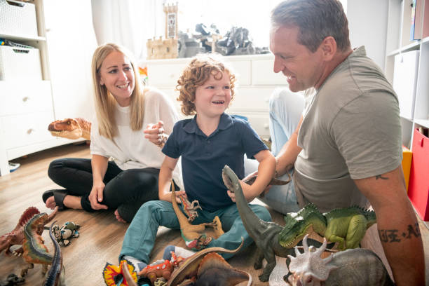 istock Cheerful disabled boy playing with parents at home in playroom 1094256610