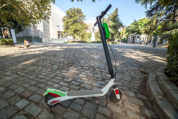 istock Dockless electric kick scooters from a scooter-sharing system parked on a sidewalk 1094256720