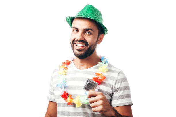 Portrait of young brazilian man wearing carnival costume showing a condom Portrait of young brazilian man wearing carnival costume showing a condom condom photos stock pictures, royalty-free photos & images