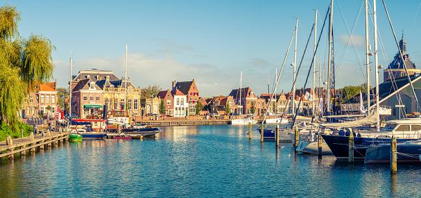 Panorama of old harbour with boats and quayside in historic city of Enkhuizen, North Holland, Netherlands