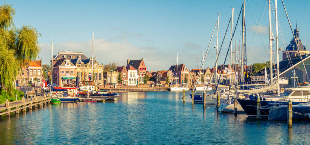 Panorama of old harbour and quayside in historic city of Enkhuizen, North Holland, Netherlands Panorama of old harbour with boats and quayside in historic city of Enkhuizen, North Holland, Netherlands enkhuizen stock pictures, royalty-free photos & images