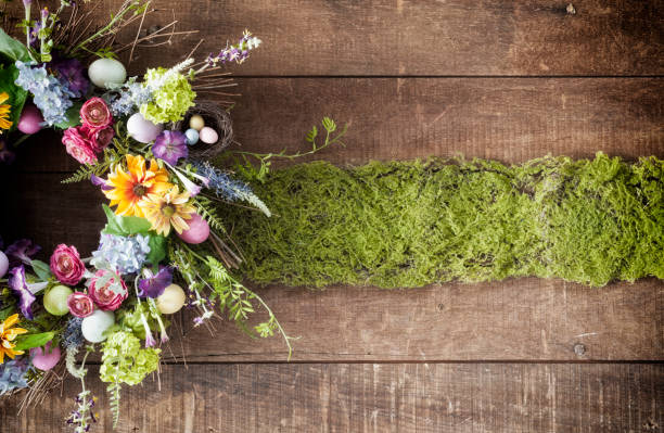 istock Easter spring flower wreath with Easter eggs on an old wood background 1094268736