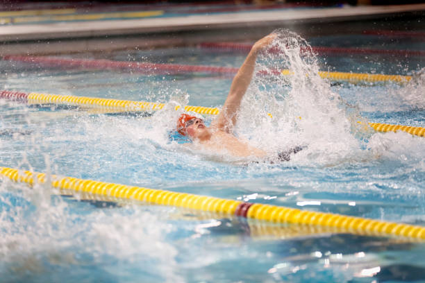 istock Young man swimming backstroke for school sports 1094273552
