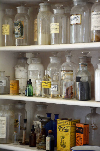 istock Antique apothecary bottles on white shelves 1094275408