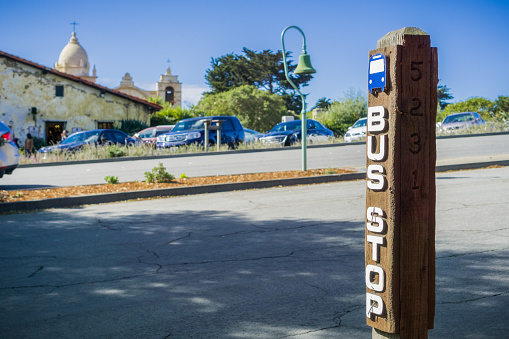 Bus stop on Junipero Serra; Carmel Mission in the background, Carmel-by-the-Sea, Monterey Peninsula, California