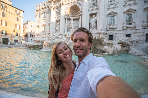 Selfie portrait of young couple in Rome at the Trevi fountain, Italy