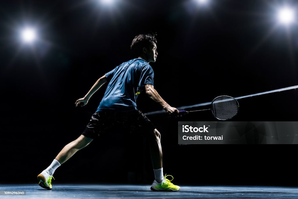 Asian badminton player is hitting in court Badminton - Gloucestershire Stock Photo