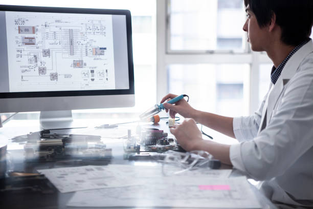 Researchers who confirms the design drawing on a personal computer.