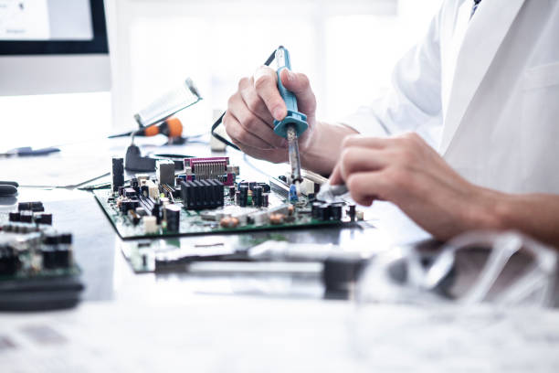 istock A young scientist who solders on an electronic board. 1094304686