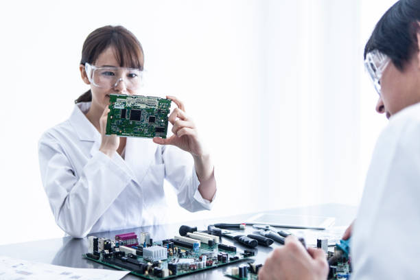 istock Female researcher who confirms the electronic board. 1094304880