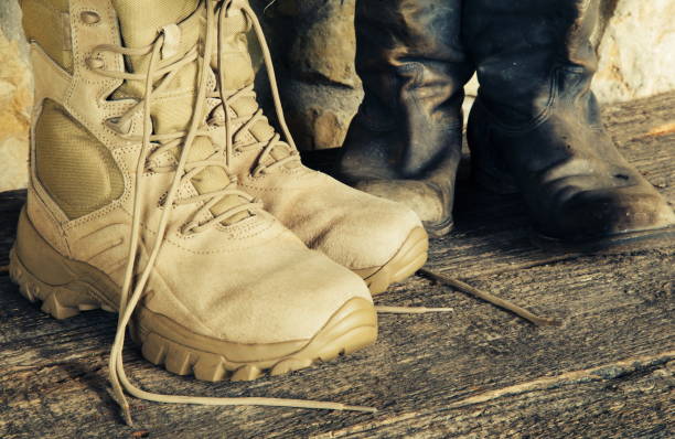 istock New and old military boots. 1094309088