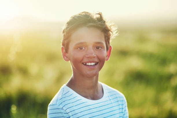 Portrait of a little boy standing outdoors