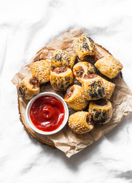 istock Minced puff pastry rolls - delicious snacks, tapas on light background, top view. Flat lay. Sausage rolls 1094323838