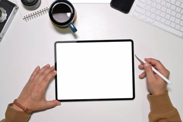 istock Top view of young man worker using on modern touchscreen tablet 1094325304