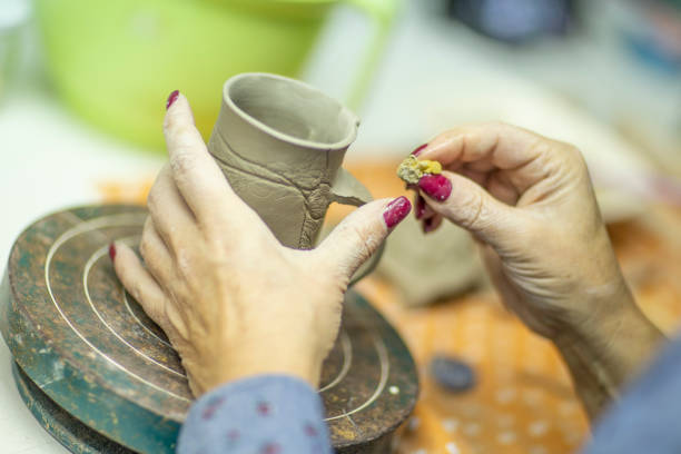 istock Hands of artist who make a mug from ceramic clay in studio 1094331612