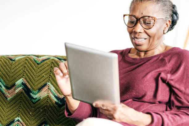 istock Senior women at home using tablet 1094334442
