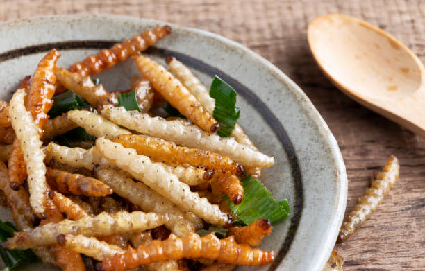 istock Bamboo edible worm insects crispy or Bamboo Caterpillar in a ceramic bowl on a wood table. The concept of protein food sources from insects. It is a good source of protein, vitamin, and fiber. 1094340416