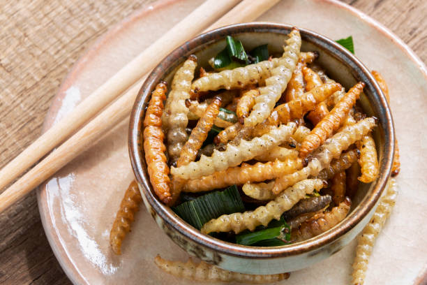 istock Bamboo edible worm insects crispy or Bamboo Caterpillar in a ceramic bowl on a wood table. The concept of protein food sources from insects. It is a good source of protein, vitamin, and fiber. 1094340418