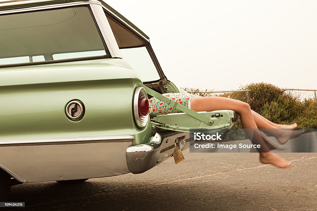 Two girls lying in estate car  Retro Style Stock Photo
