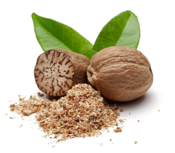 istock Nutmeg granules and nutmegs with leaves 1094343306