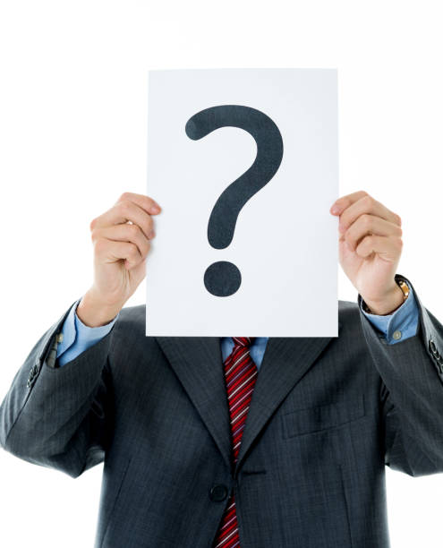 istock Confused businessman holding question mark 1094346150