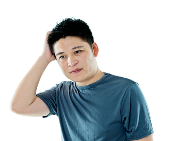 istock Young man headache against white background 1094349064