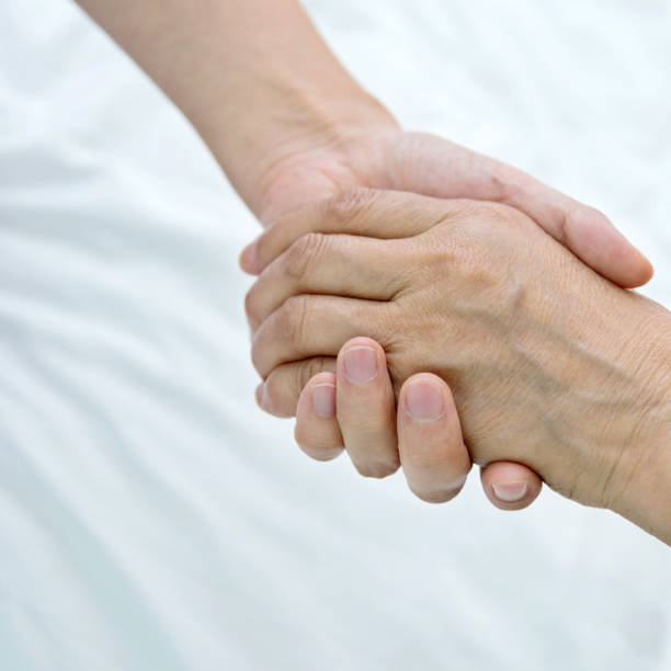 istock Young hands holding a senior woman's hands 1094351662