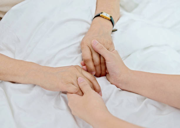 istock Young hands holding a senior woman's hands 1094351708