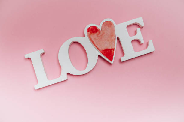 istock Single word LOVE with wooden hearts 1094354792