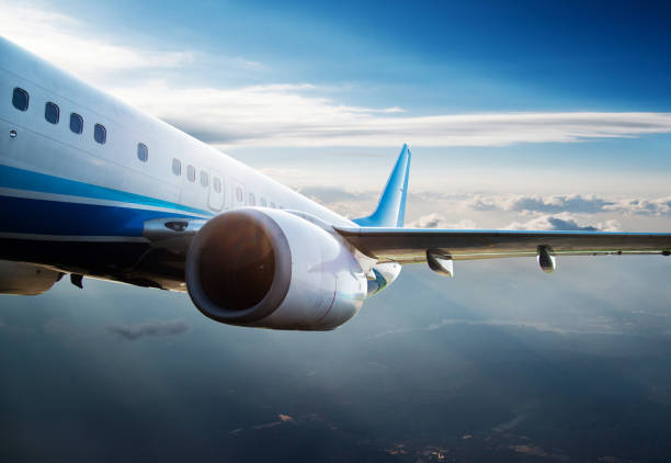 istock Commercial airplane flying over clouds 1094355288