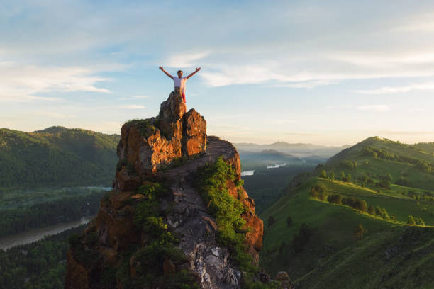 istock Man standing on top of cliff 1094357436