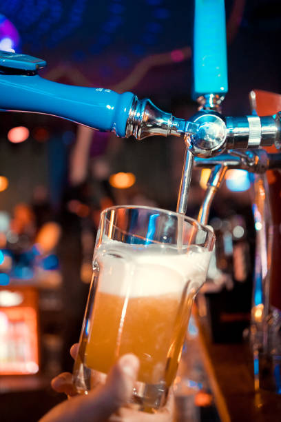 istock Bartender pouring from tap fresh beer into the glass in pub 1094357632