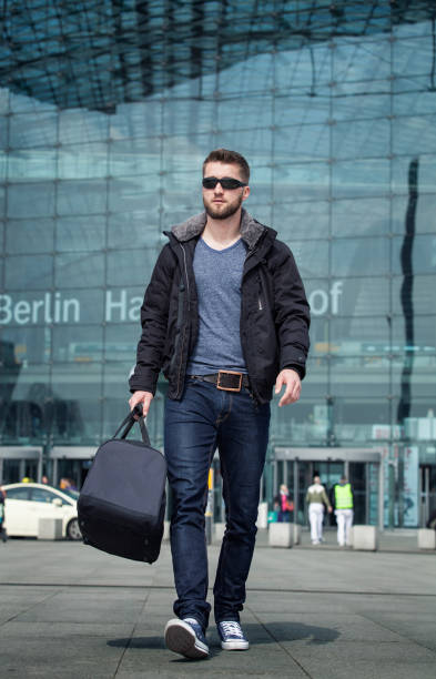 istock Attractive man is walking with a bag in his hand 1094365816