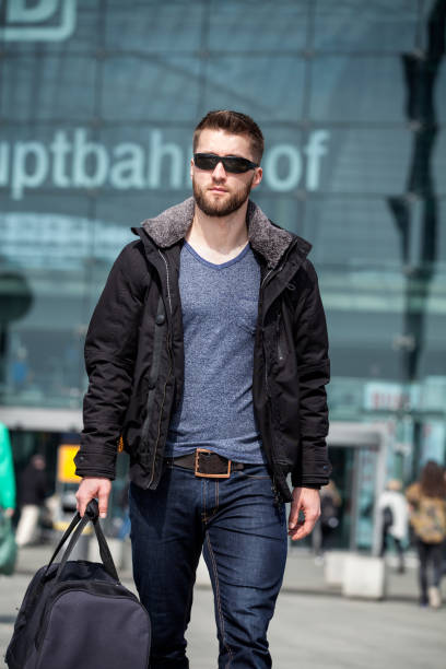 istock Attractive man with sunglasses and a suit case 1094365914