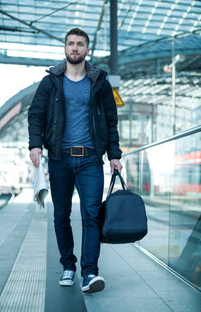 istock Attractive man is walking with a bag in his hand 1094367344
