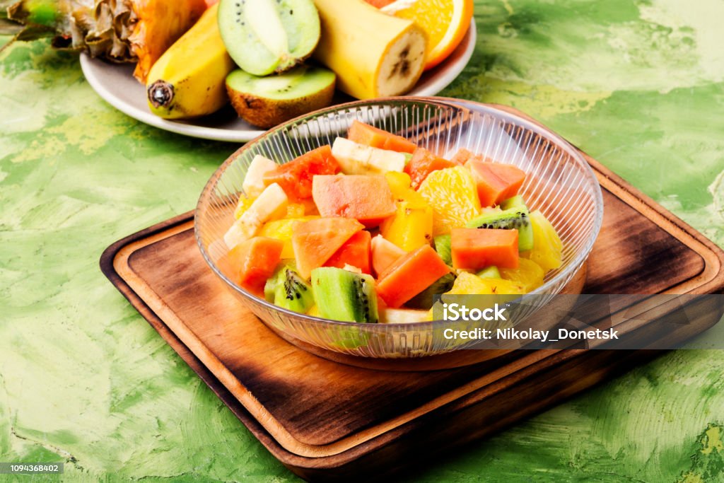 Bowl of fresh fruit salad Fresh fruit salad on gray stone table.Colorful fruit salad Banana Stock Photo