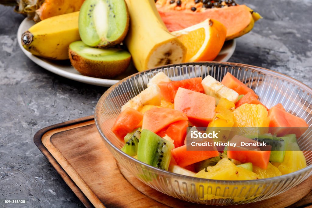 Bowl of fresh fruit salad Fresh fruit salad on gray stone table.Colorful fruit salad Banana Stock Photo