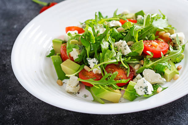 istock Dietary salad with tomatoes, blue cheese, avocado, arugula and pine nuts. 1094375528