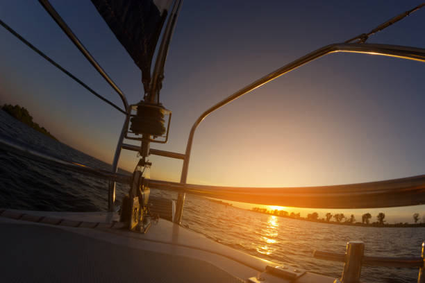istock Sailing at sunset. A view from the yacht's deck to the bow and sails. 1094378718